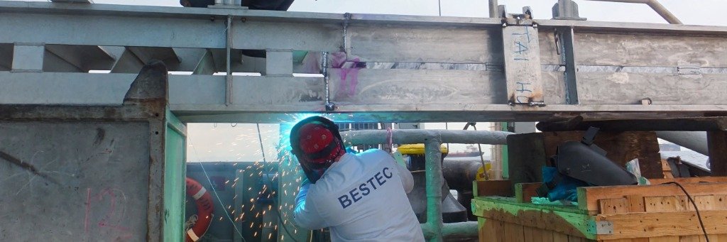 Welder with BESTEC shirt welding on shipyard structure